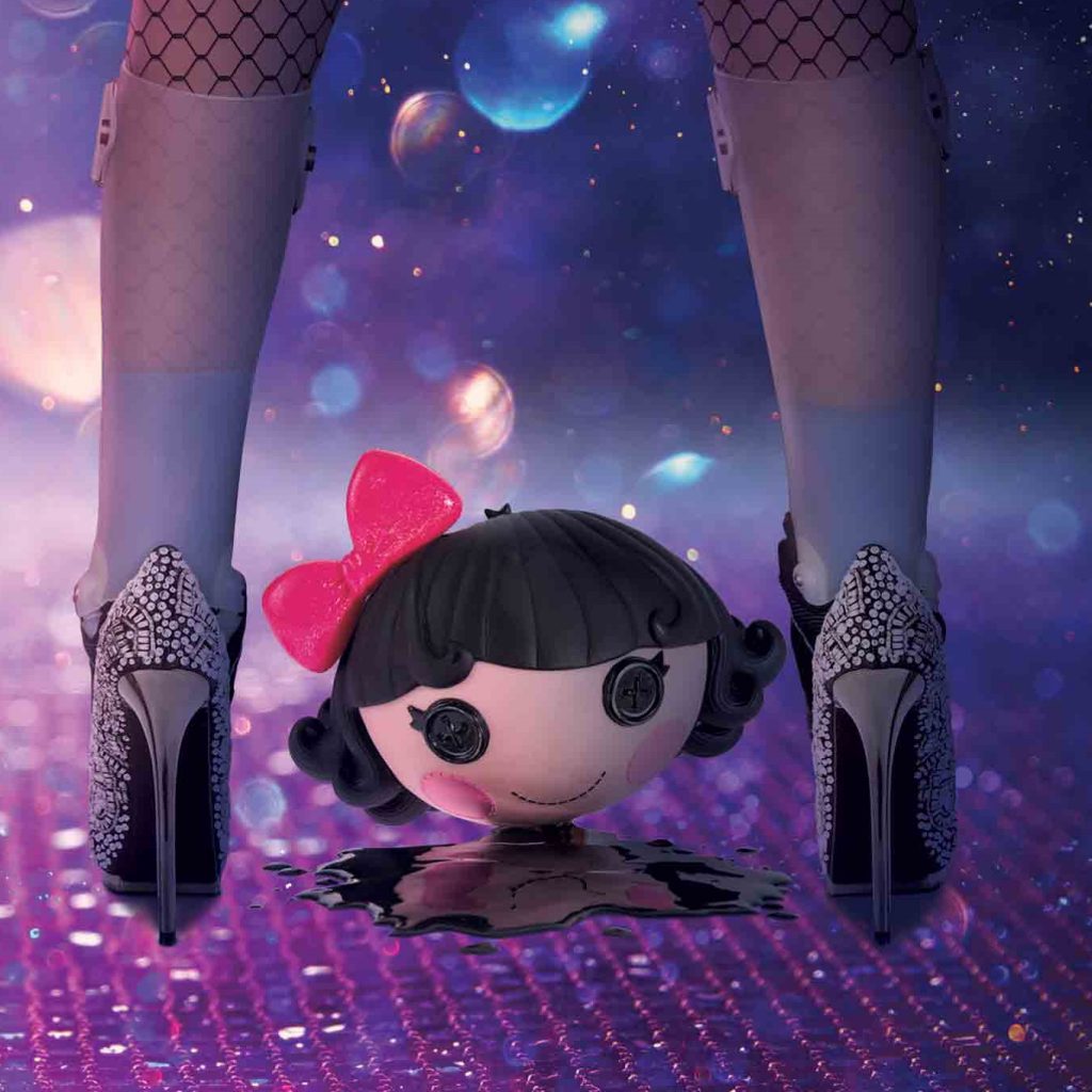 A graphic showing a pair of legs wearing high heels and orthoses standing on a glittery dance floor with The Sisters of Invention doll's head