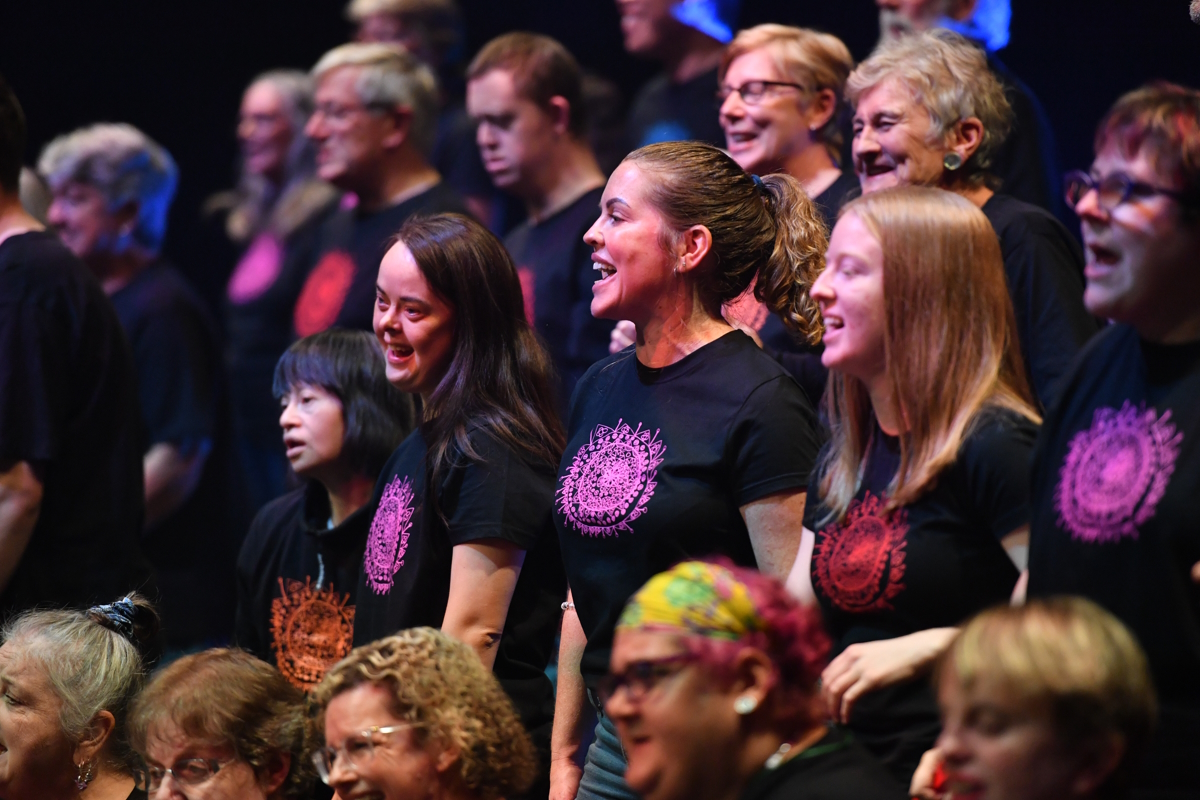 A group of people sing on stage