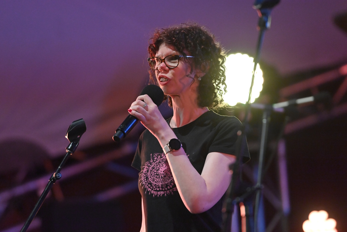 Aimee Crathern singing into a microphone