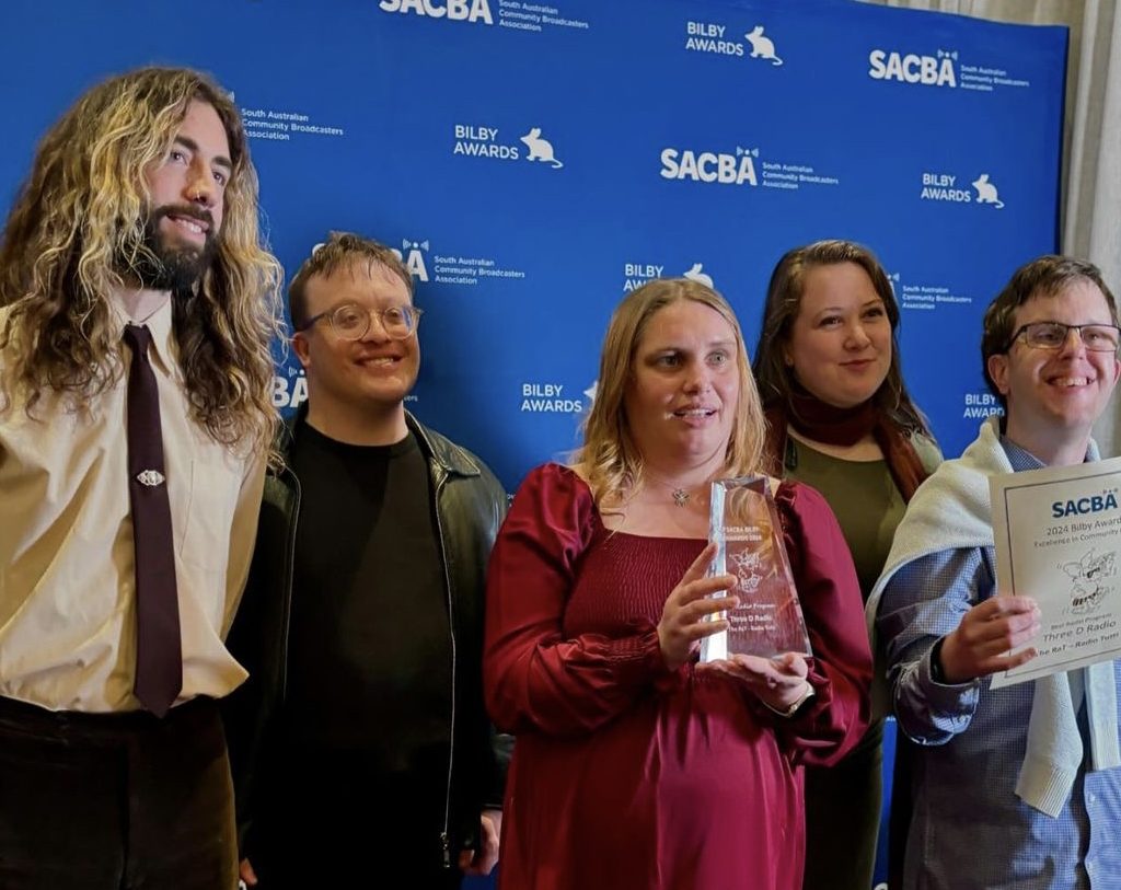 5 people smile as they accept an award