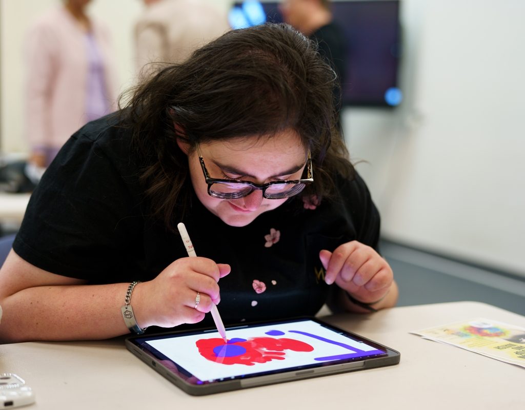 A person drawing on a tablet