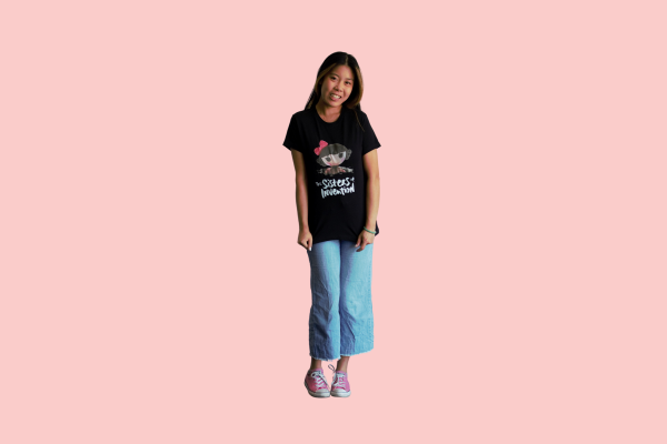 Person wearing black t-shirt with The Sisters of Invention logo featuring a doll's head in black paint.