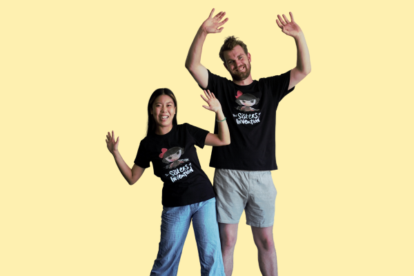 Two people wearing black t-shirt with The Sisters of Invention logo featuring a doll's head in black paint.