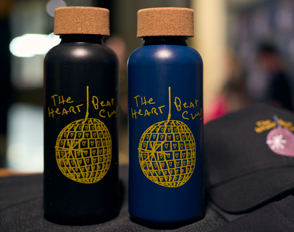 Black and navy water bottles with the Heart Beat Club logo in yellow