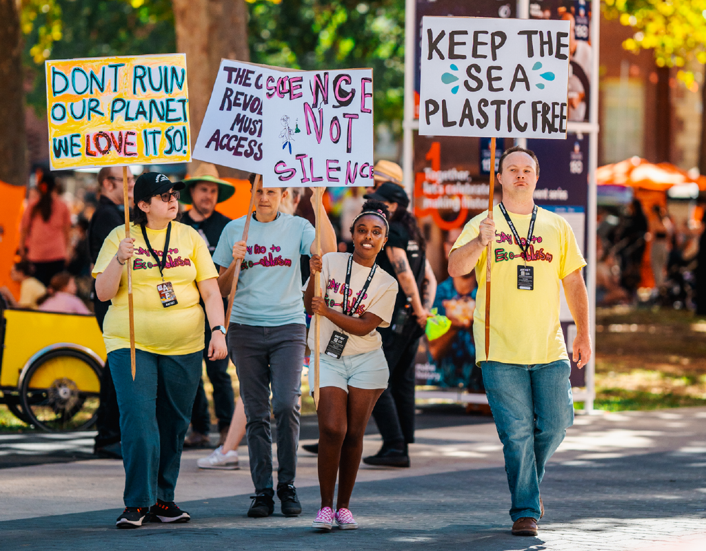 An image of artists holding climate change protest signs