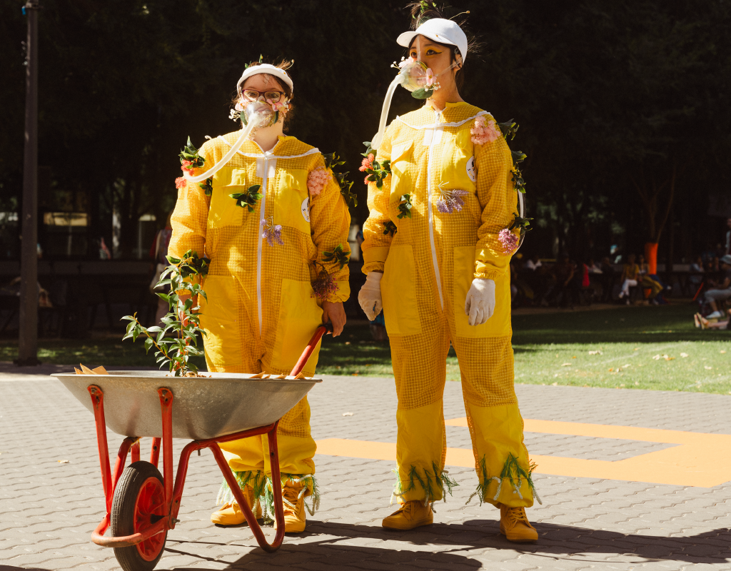 Two artists in bee suits as part of Floods of Fire