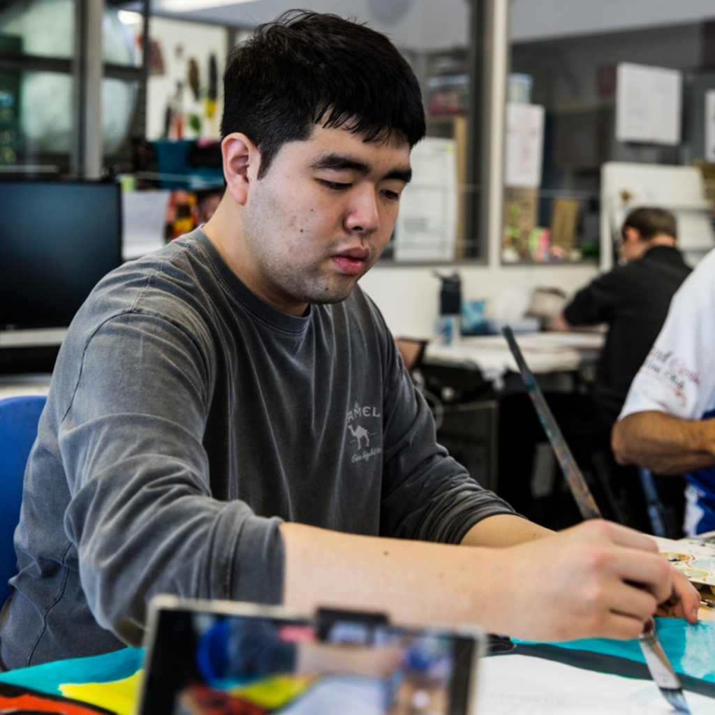 People painting with camera set up.