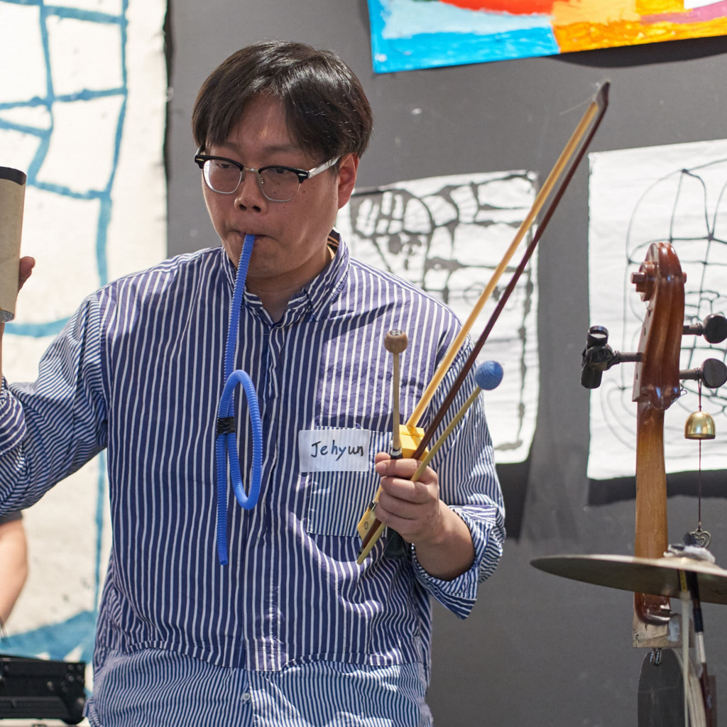 Person playing traditional Korean instruments.