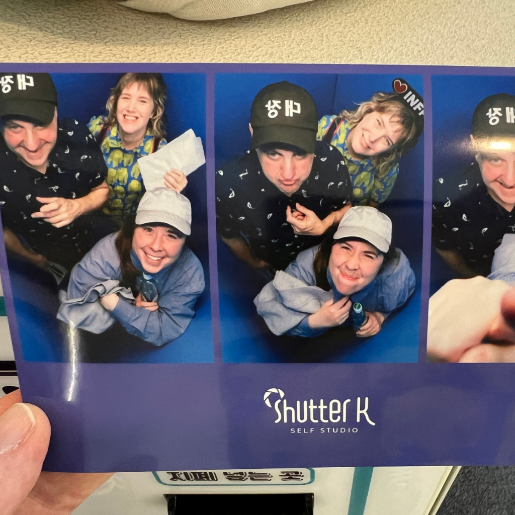 Photo booth photos of three people smiling up into the camera.