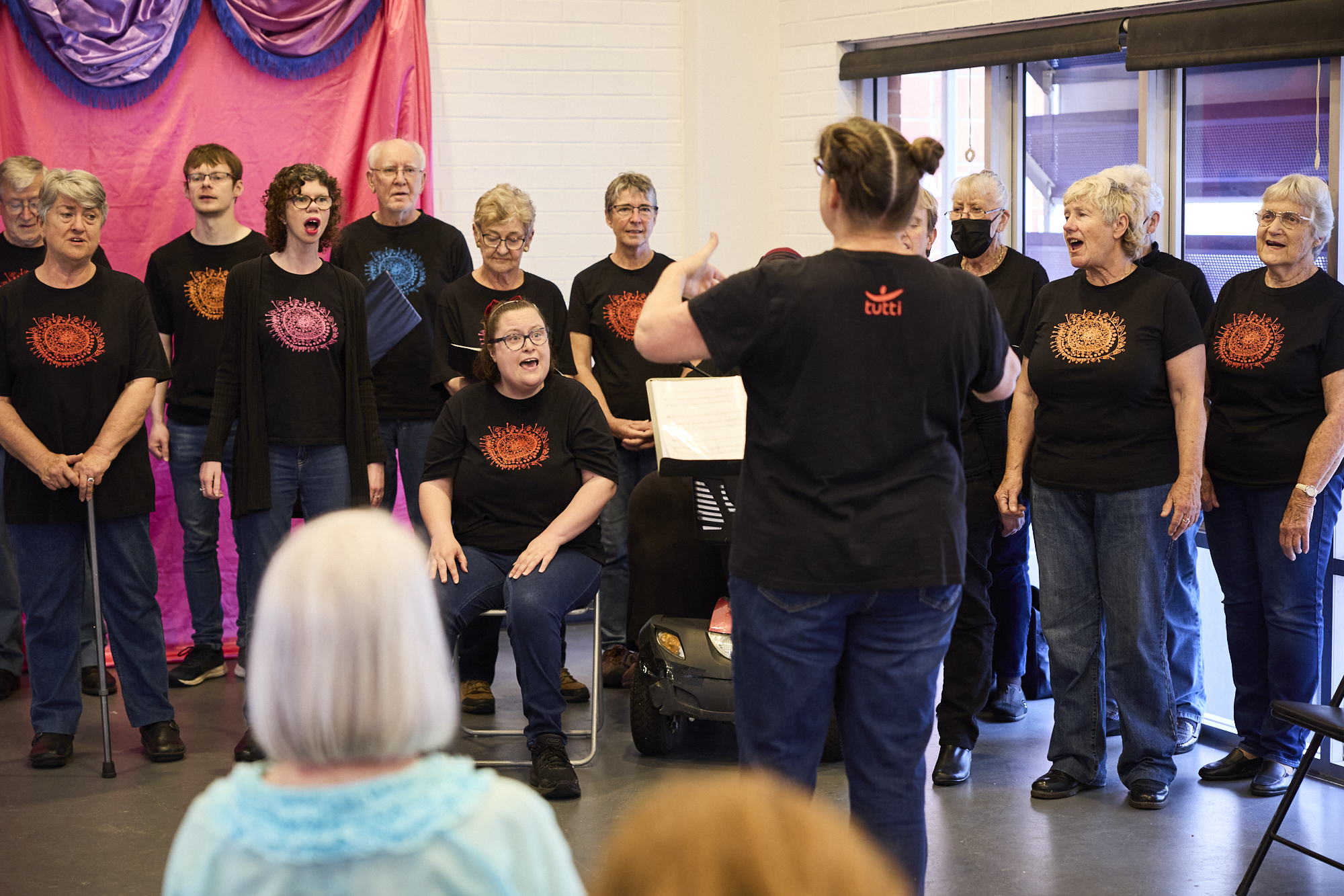 Members of Poco Tutti Choir singing. 