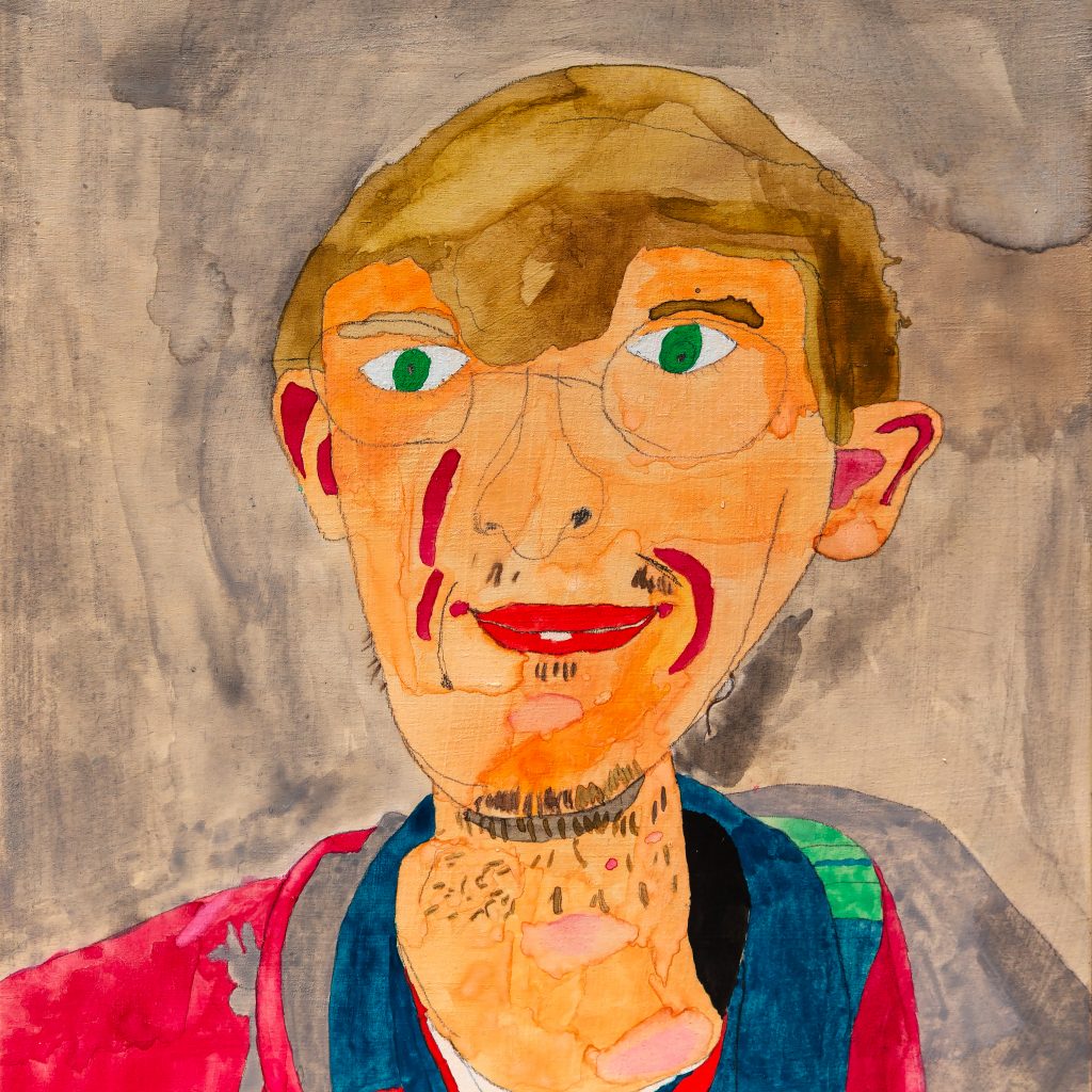 Self portrait of Kit Jury in graphite and acrylic - he has short, blond hair, green eyes and think rimmed glasses. He has a slim face with a little blond stubble and is wearing a bright red, green and blue jacket.