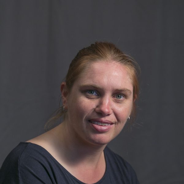 Headshot of Megan Long - she has blonde hair tried in a ponytail and is smiling at the camera.