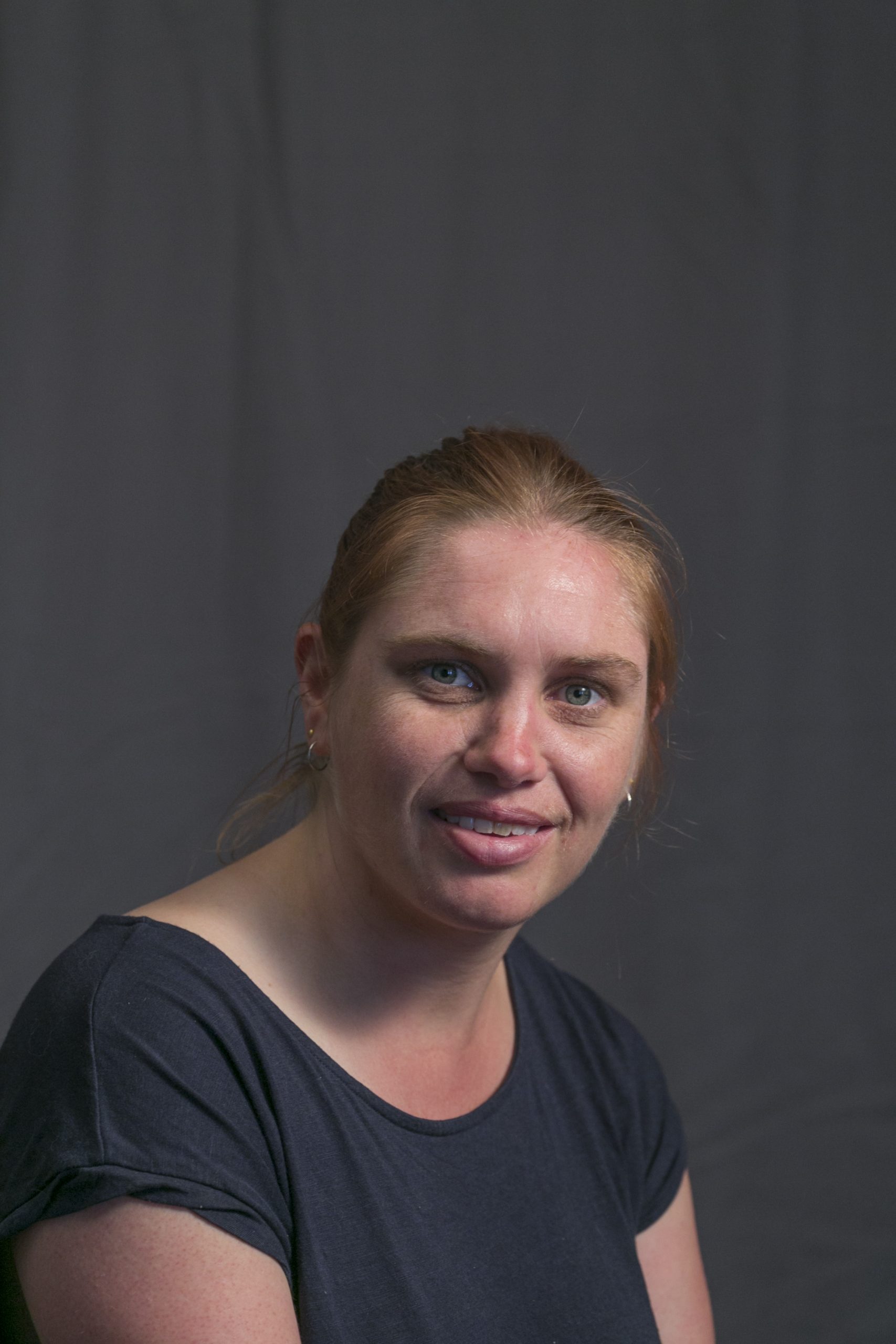 Headshot of Megan Long - she has blonde hair tried in a ponytail and is smiling at the camera.
