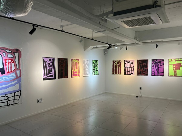 Lewis' works hanging on the wall at his exhibition in Korea. 